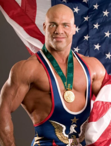 A man with a medal around his neck and an american flag behind him.