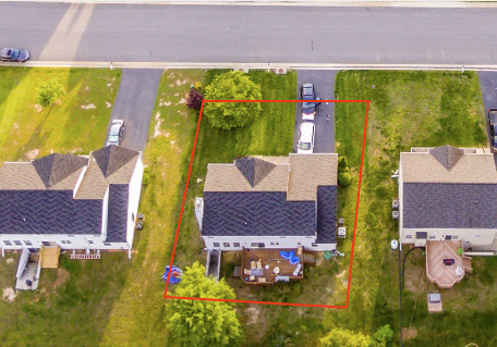 A aerial view of houses with a red line drawn across the top.