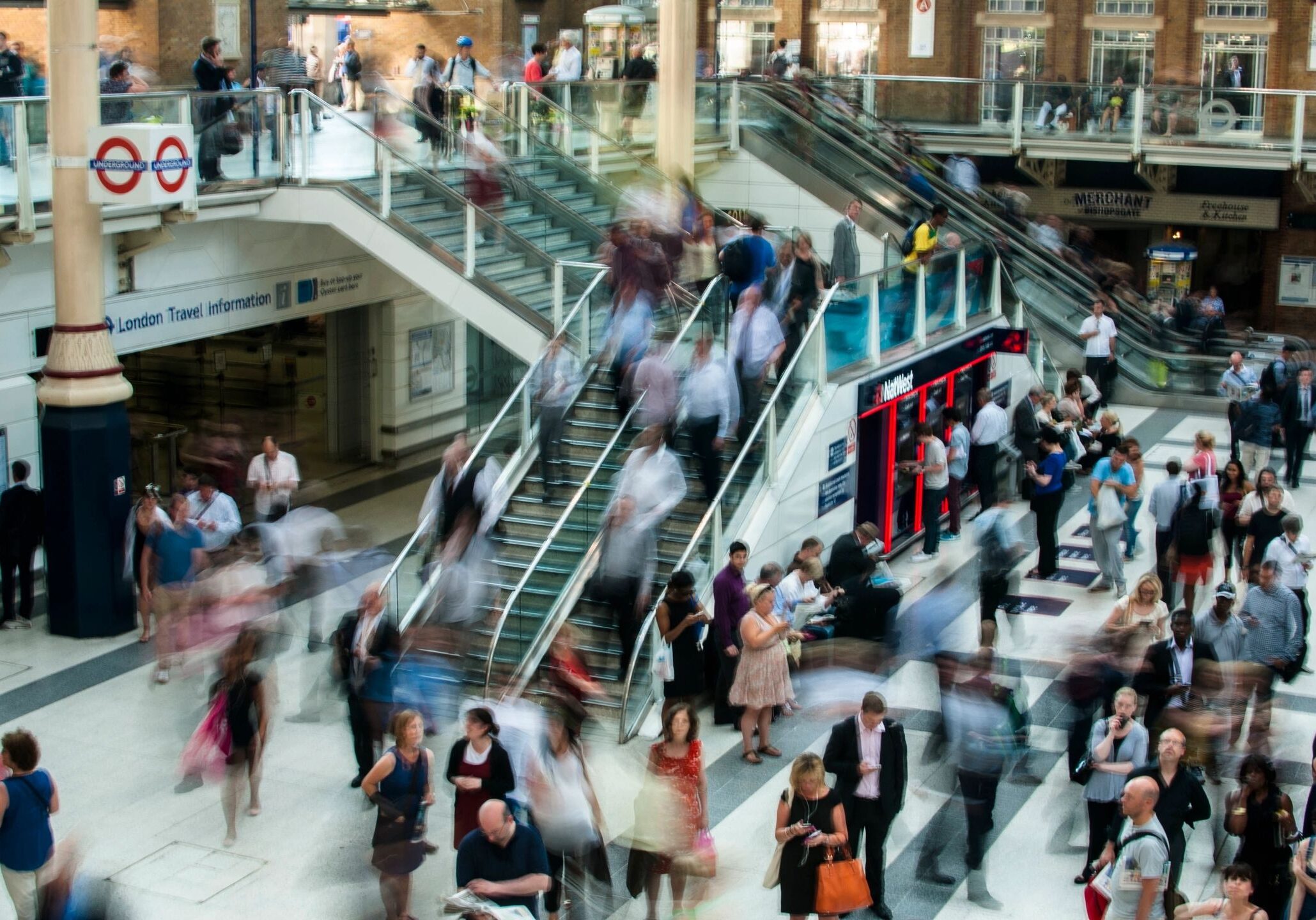 A crowd of people walking up and down stairs.